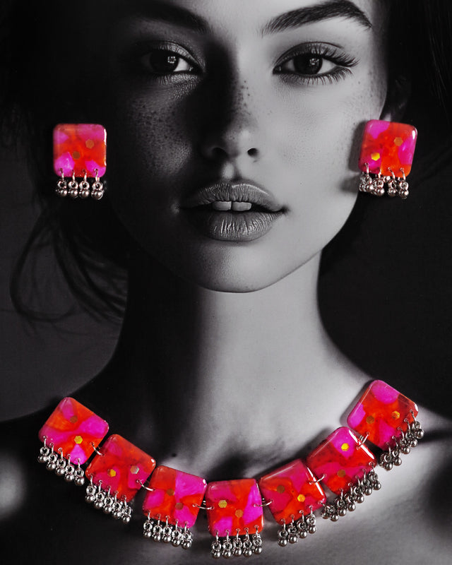 a model wearing the Aynoor pink floral jewelry set, featuring delicate pink floral designs and intricate details that add a graceful and feminine touch to the overall look — Muselot.