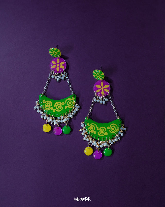 A detailed front view of Baharaan green chandbali earrings, highlighting the graceful arch design, delicate bead accents, and vibrant hand-painted details that showcase the artistry and festive charm — Muselot.