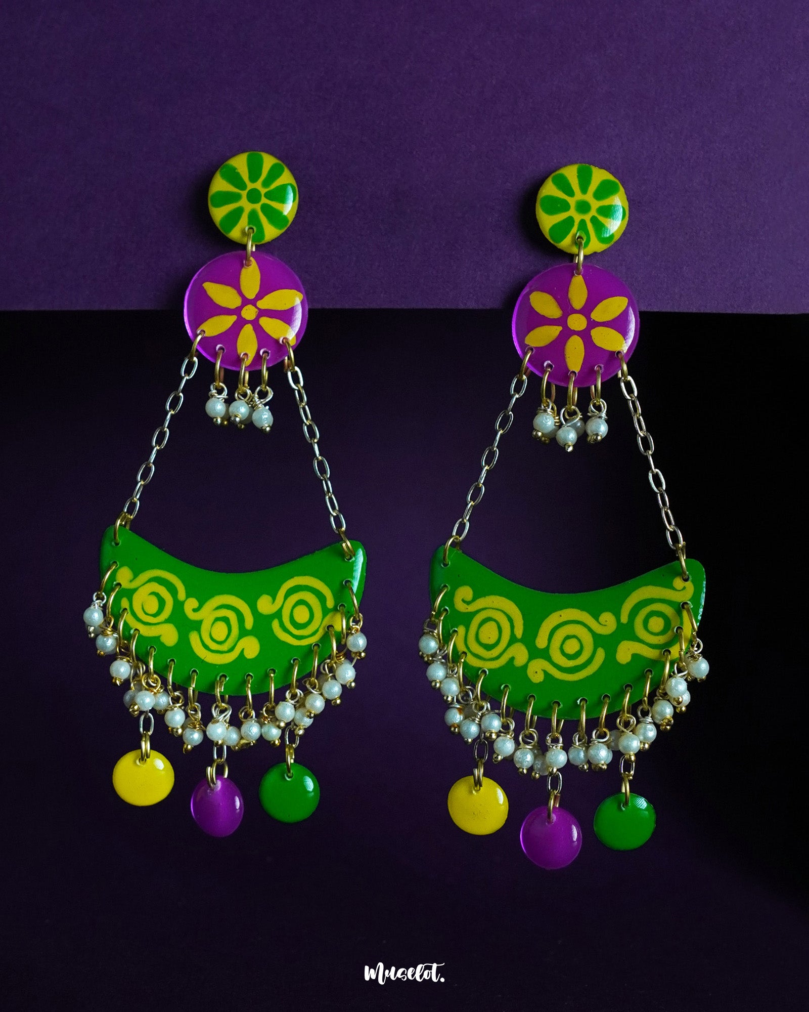 Baharaan jhumkas featuring playful crescents in green, yellow, and purple, highlighting festive charm and showcasing intricate beadwork with a handcrafted flair — Muselot.