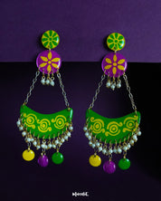 Baharaan jhumkas featuring playful crescents in green, yellow, and purple, highlighting festive charm and showcasing intricate beadwork with a handcrafted flair — Muselot.