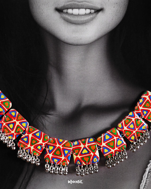 Close-up shot of a model wearing the Bandhani handmade necklace, showcasing intricate Bandhani patterns and vibrant colors that add a traditional yet elegant flair to the overall look — Muselot.
