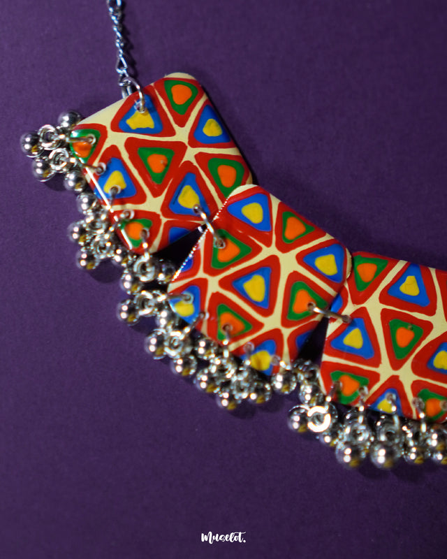 Bandhani handmade necklace, showcased against a soft background, with distinct tie-dye motifs and rich colors that add a lively yet elegant touch to its traditional craftsmanship — Muselot.