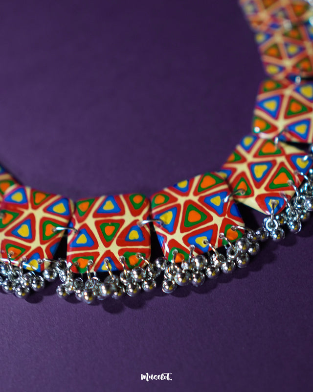 Bandhani handmade necklace, placed against a soft-toned background, featuring vivid Bandhani prints and detailed textures that celebrate the richness of traditional design with a modern, elegant twist — Muselot.