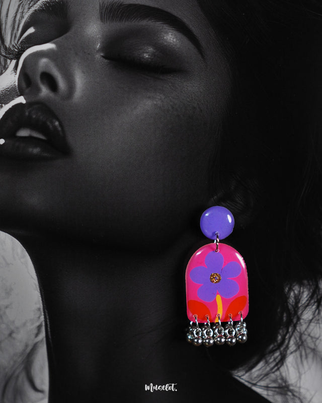 Close-up of the Benazir handmade floral drop earrings worn by the model, highlighting the delicate petal textures and soft, that lend a refined charm to the handcrafted design — Muselot