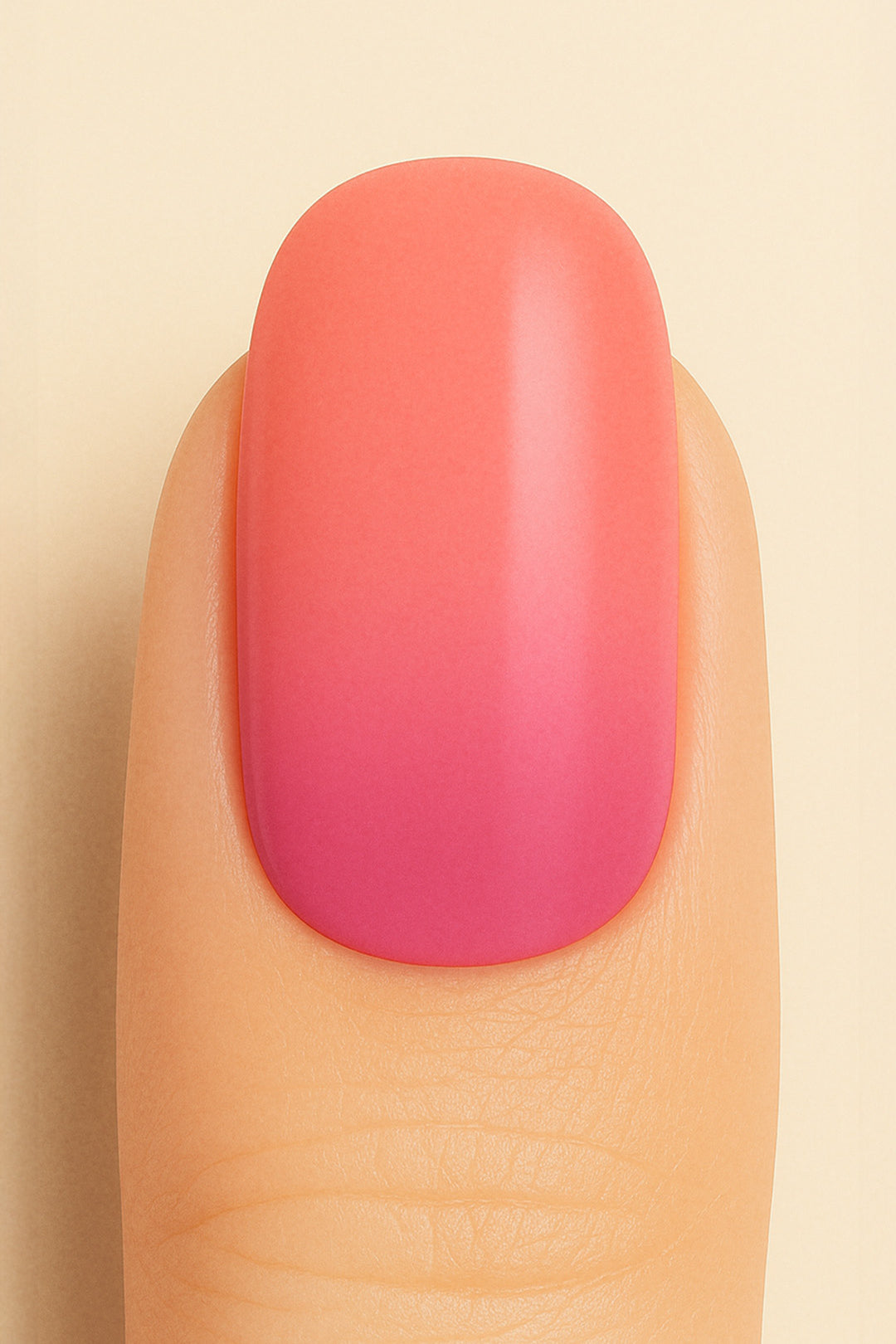 A close-up shot of a model’s finger wearing Berry Bliss Ombre nail stickies, showcasing a smooth gradient that transitions from a bright coral-pink top to a deeper berry hue at the base, highlighting the playful blend of warm tones with a glossy salon-like finish – Muselot.