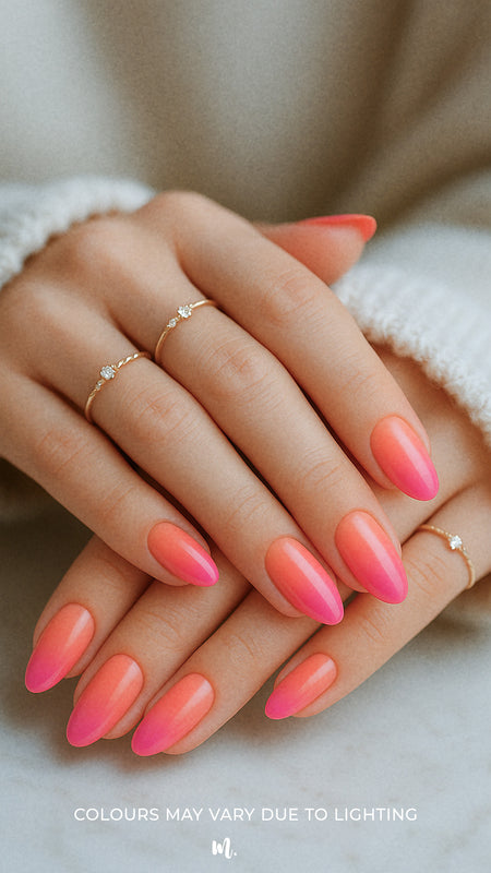 A styled shot of a model’s hands wearing Berry Bliss Ombre nail stickies, showcasing the seamless gradient blending from coral-pink to a rich berry tone across all nails, highlighting the elegance of coordinated ombre nail art with a glossy, salon-like finish – Muselot.