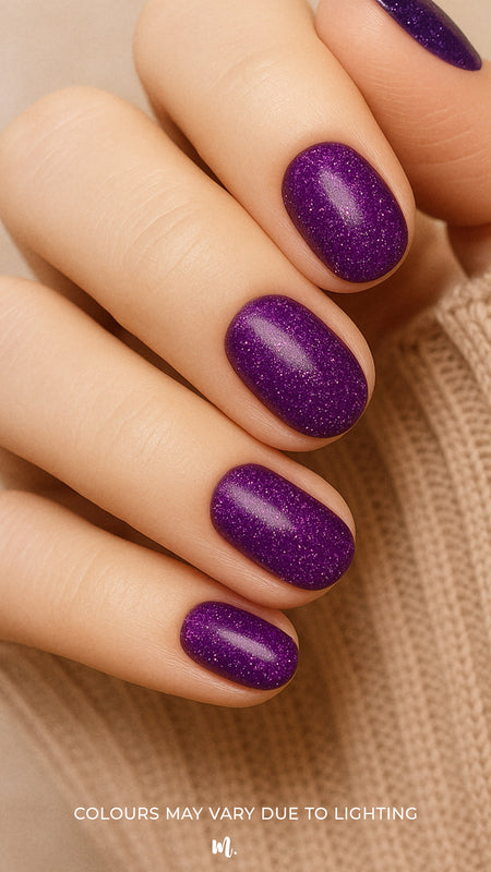 A model hand styled with Berry Cosmos Glitter nail stickies, showcasing a deep purple base lit up with tiny pink, blue, and violet sparkles. The look highlights the galaxy-like shine and bold elegance of this cosmic-inspired glitter manicure – Muselot.