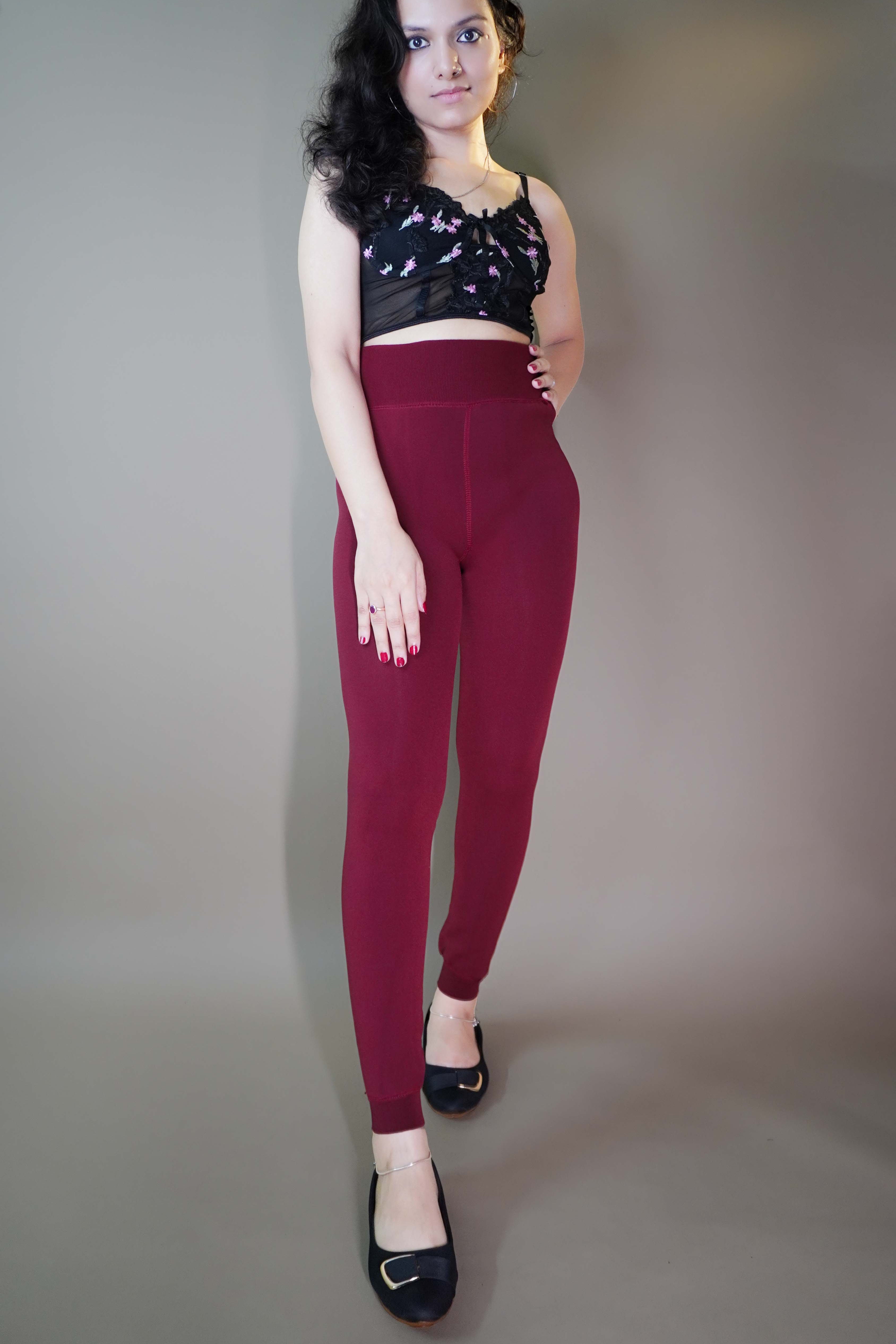 A model, wearing berry maroon warm stockings, highlighting their rich, deep color combined with a soft, insulating fabric. The stockings provide both warmth and style, adding a cozy, vibrant touch to any outfit. -Muselot