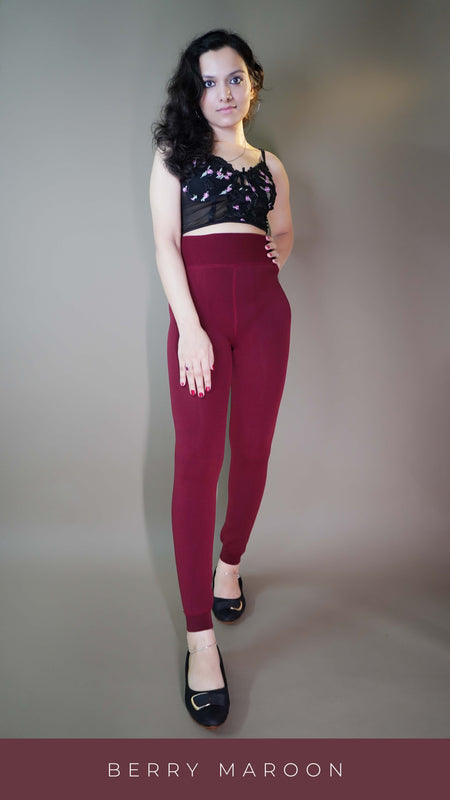 A model, wearing berry maroon warm stockings, highlighting their rich, deep color combined with a soft, insulating fabric. The stockings provide both warmth and style, adding a cozy, vibrant touch to any outfit. -Muselot