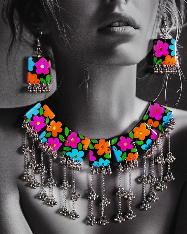 A woman wearing the black floral necklace set, styled elegantly to highlight the handcrafted floral details and the deep black tones that stand out beautifully against her outfit — Muselot.