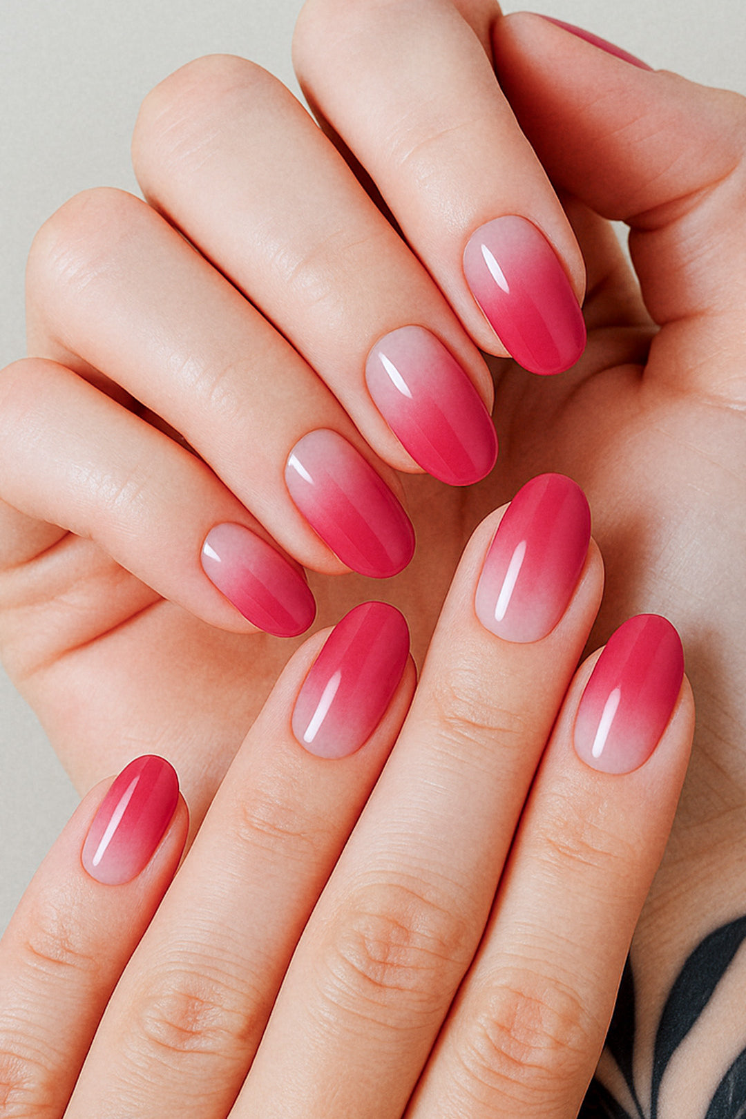 A model hand styled with Blush Mist Pink Ombre Nail Polish Stickies, featuring a seamless transition from soft blush pink at the base to a deeper rose-red tip, highlighting a glossy and elegant gradient finish that feels both subtle and striking – Muselot.