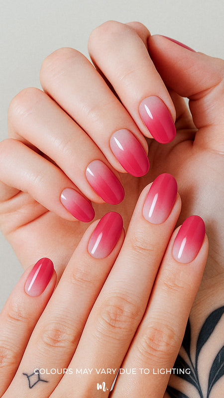 A model hand styled with Blush Mist Pink Ombre Nail Polish Stickies, featuring a seamless transition from soft blush pink at the base to a deeper rose-red tip, highlighting a glossy and elegant gradient finish that feels both subtle and striking – Muselot.
