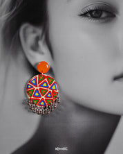 Close-up shot of a model wearing Chakardi traditional art earrings, featuring detailed craftsmanship and traditional motifs that highlight their elegant and timeless appeal — Muselot.