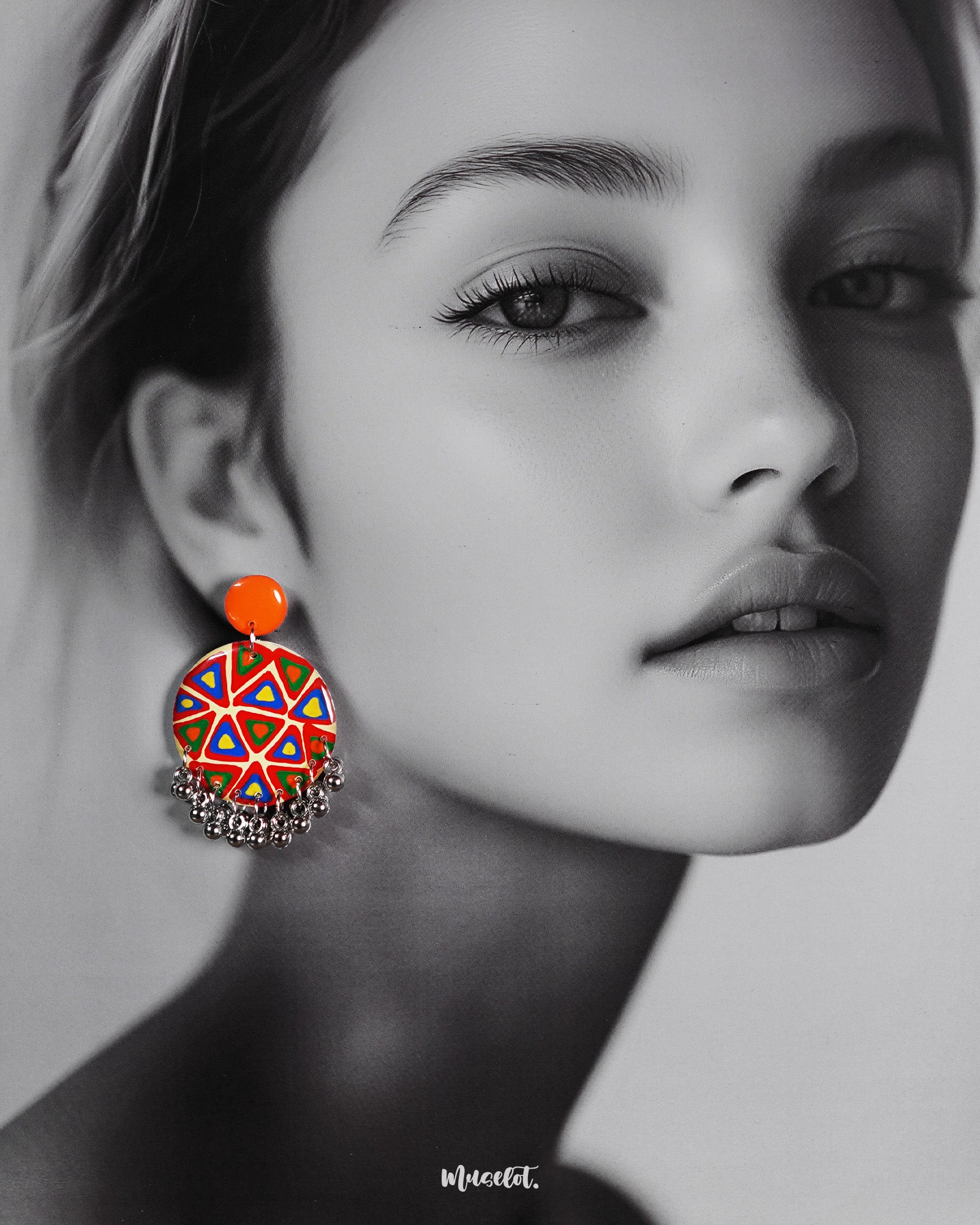 A model wearing Chakardi traditional art earrings, adorned with intricate patterns and bold designs that add a rich, cultural charm and sophisticated elegance to any look — Muselot.
