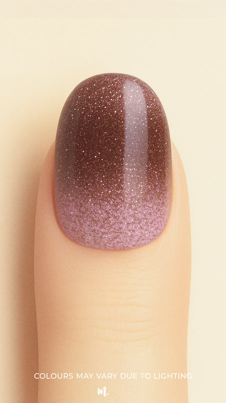 A close-up shot of a model’s finger wearing Choco Plum Glitter Ombre nail stickies, showcasing the smooth gradient that shifts from soft plum to deep chocolate brown, highlighted with fine sparkling glitter for a rich ombre effect that adds depth, elegance, and a salon-style glossy finish – Muselot.