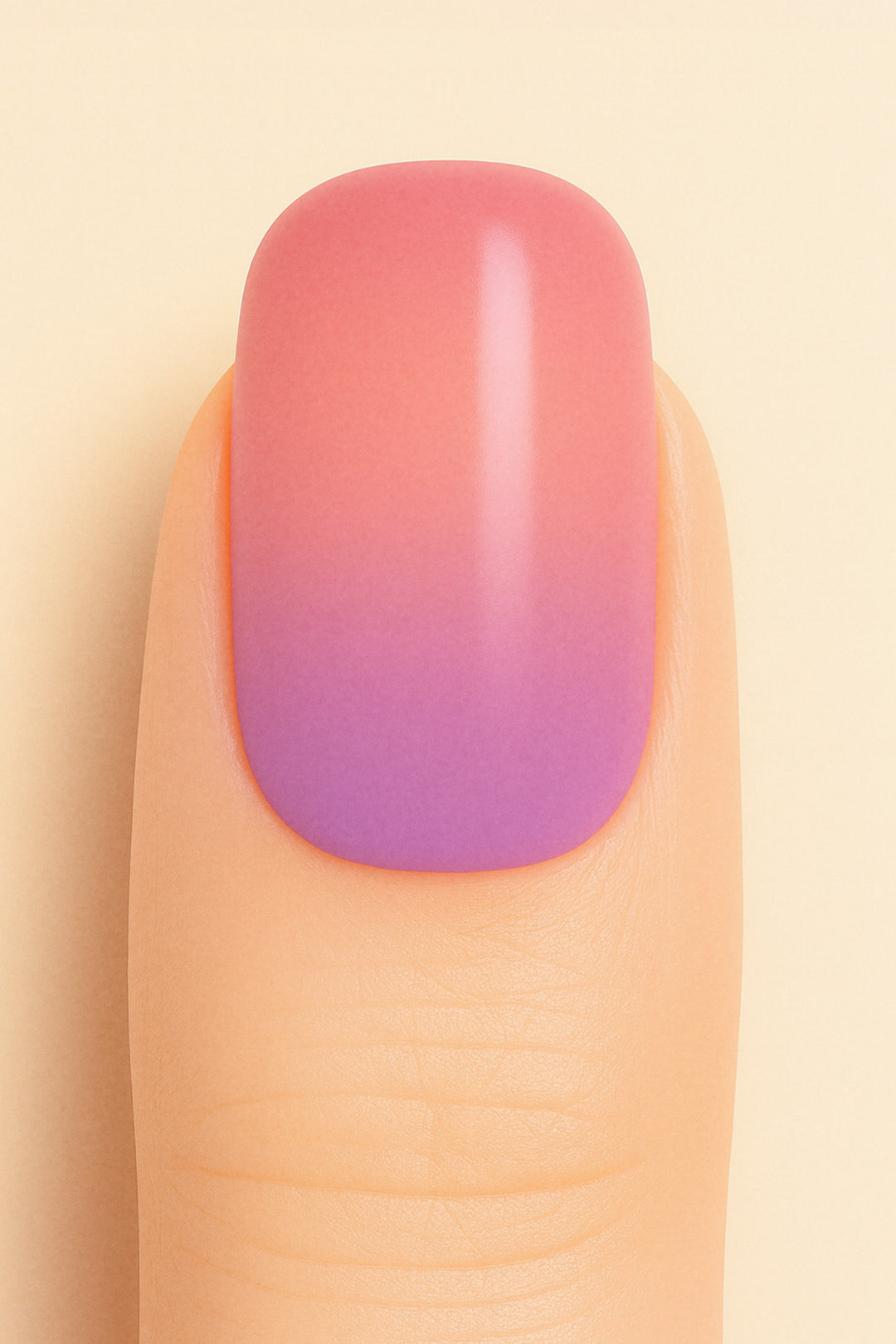A close-up shot of a model’s finger wearing Coral Kiss Ombre Nail Stickies, showcasing a seamless transition from soft coral pink to a delicate lilac-purple tone, highlighting the smooth glossy finish and gradient charm of ombre nail art – Muselot.