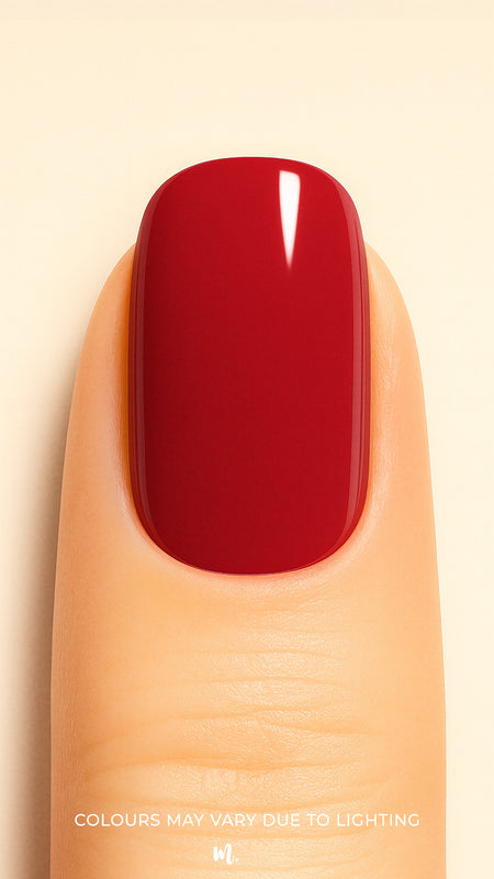 A close-up shot of a model’s finger wearing Crimson Kiss Solid Nail Stickies, showcasing a deep, bold crimson red shade with a smooth glossy finish, highlighting the rich solid color and sleek shine of the nail art – Muselot.