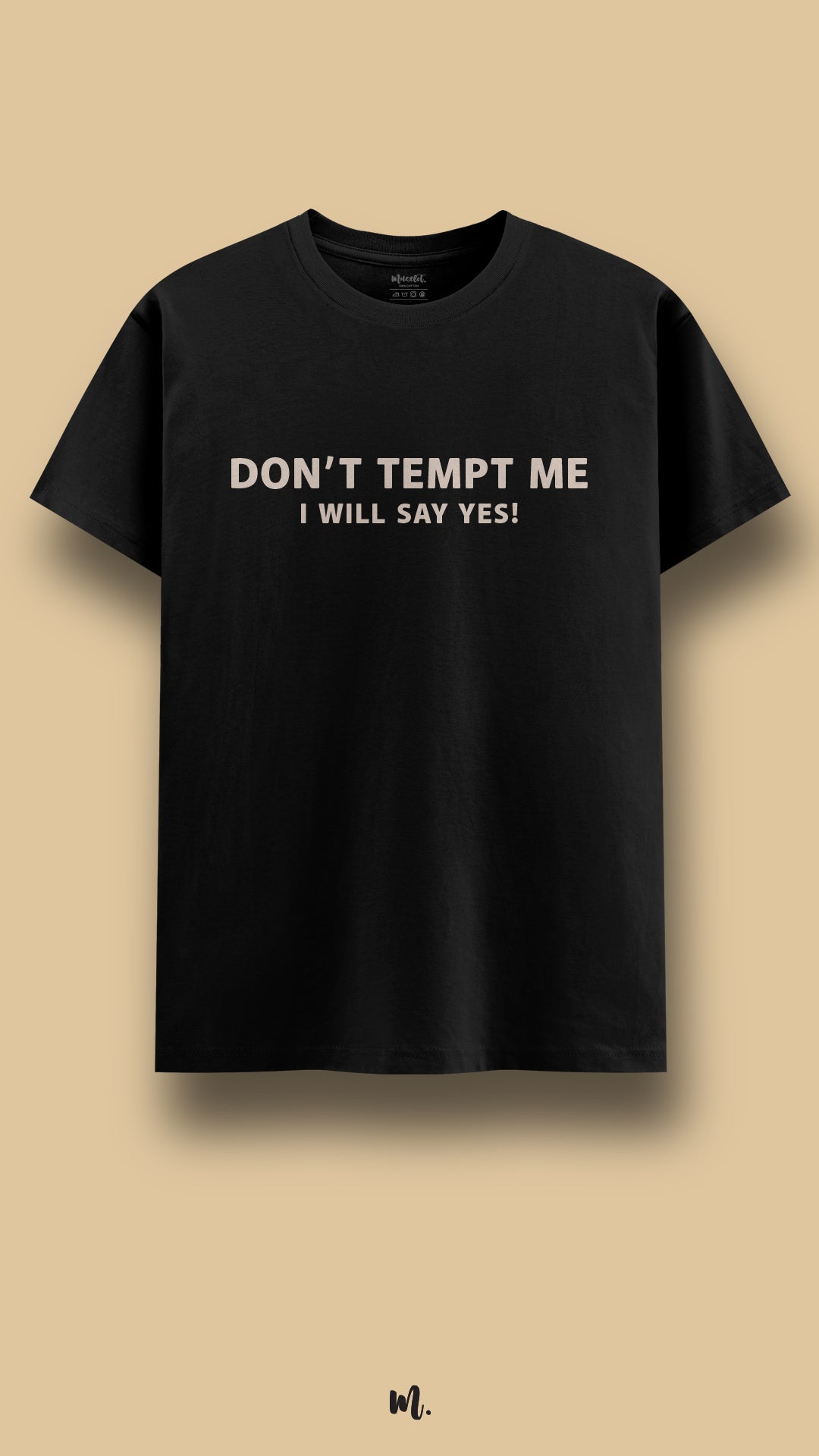 Black graphic t-shirt showcasing the “Don’t Tempt Me, I Will Say Yes!” statement, highlighting a cheeky, confident, and fun-loving vibe against a clean beige background – Muselot