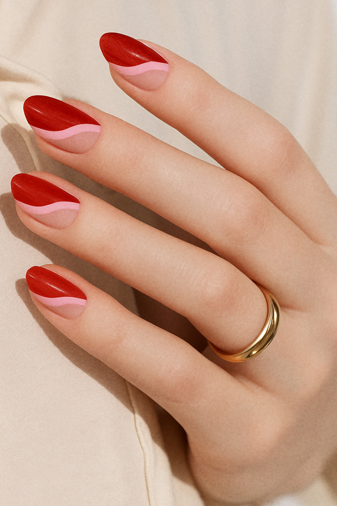 A model hand wearing Dried Rose Nail Art Stickies, showcasing bold wavy patterns in deep red, dusty rose, and pink tones, accented with glitter-lined curves. The artistic design highlights a retro yet chic look, adding a statement finish to the manicure – Muselot.