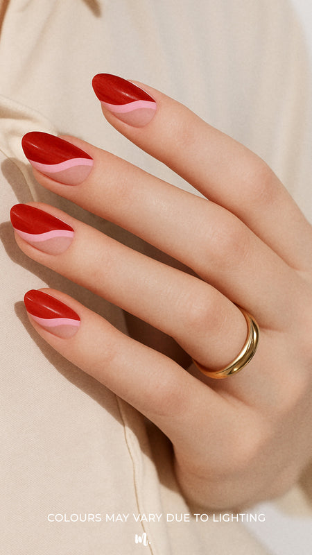 A model hand wearing Dried Rose Nail Art Stickies, showcasing bold wavy patterns in deep red, dusty rose, and pink tones, accented with glitter-lined curves. The artistic design highlights a retro yet chic look, adding a statement finish to the manicure – Muselot.