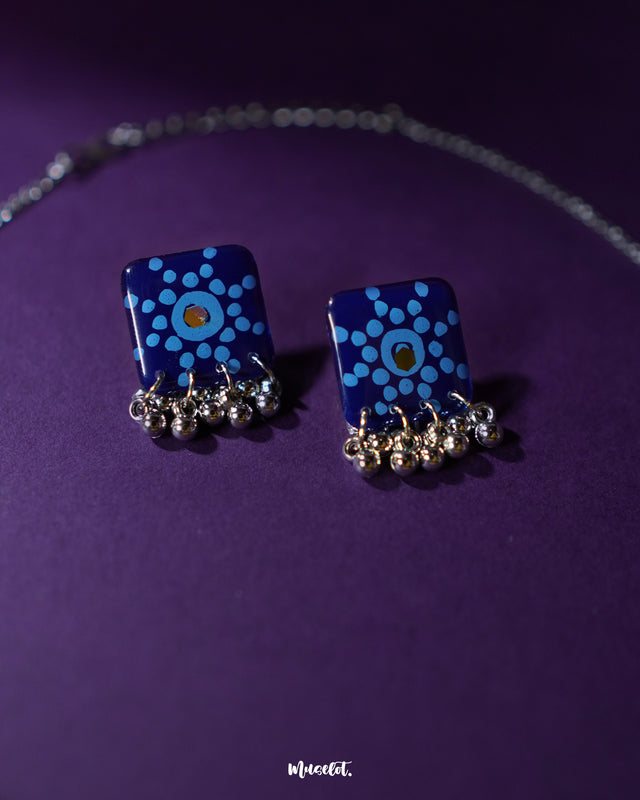 Falakzaar blue floral earrings from the set captured in a detailed view, highlighting the hand-painted patterns and showcasing the lightweight, artisanal elegance — Muselot.