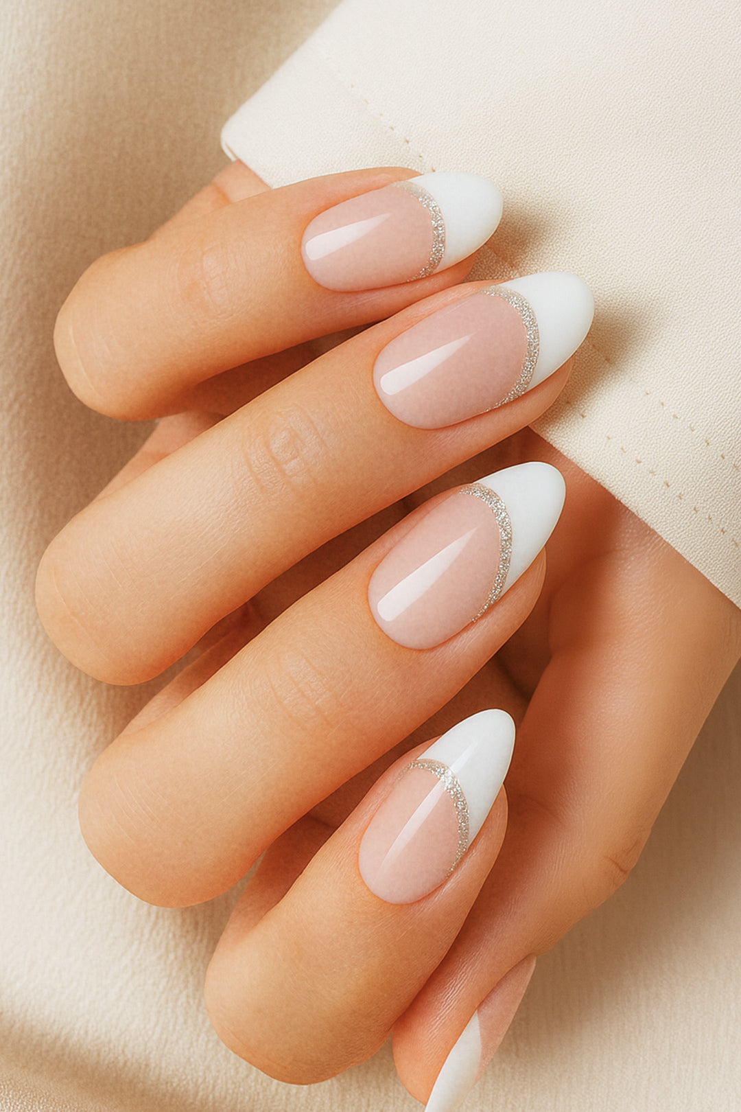 A model hand showcasing Frosted Charm French Tip Nail Stickies, featuring a soft nude base with a crisp white tip highlighted by a delicate shimmer line, capturing the timeless elegance and glossy sophistication of French manicure nail art – Muselot.