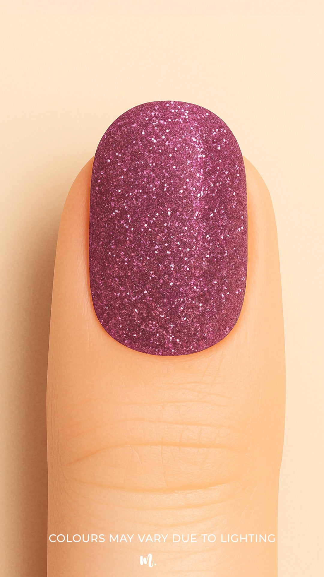 A close-up shot of a finger wearing Glitter Crush nail stickies, showcasing a deep plum-pink shade loaded with fine glitter sparkles, highlighting the rich shimmer and glossy salon-style finish that adds a glamorous pop to the nails – Muselot.