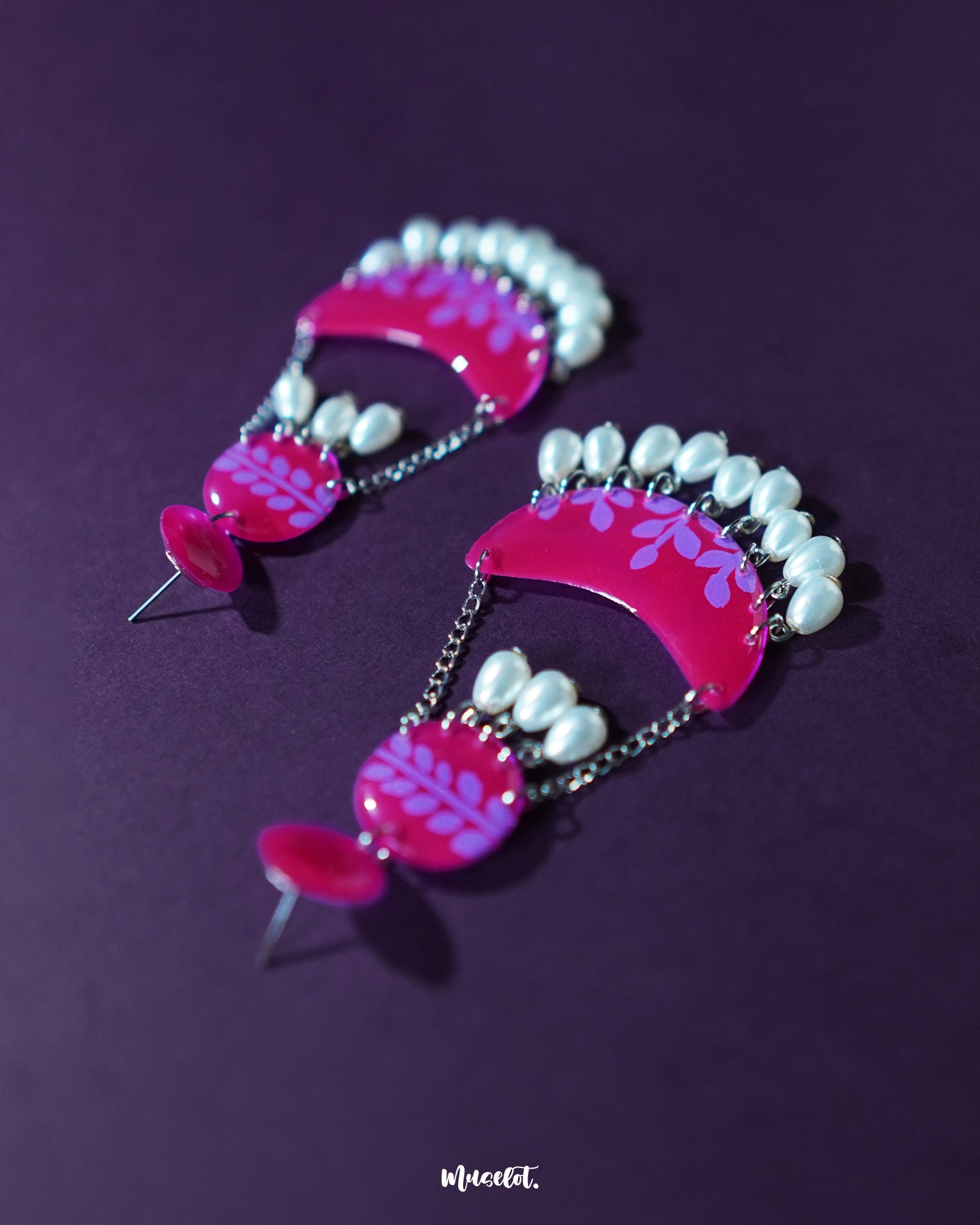 The Gulfaam pink pearl chandbali earrings displayed against a neutral backdrop highlight the ornate crescent structure, with dainty pearl drops and intricate metalwork radiating traditional elegance — Muselot.