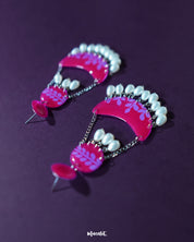 The Gulfaam pink pearl chandbali earrings displayed against a neutral backdrop highlight the ornate crescent structure, with dainty pearl drops and intricate metalwork radiating traditional elegance — Muselot.