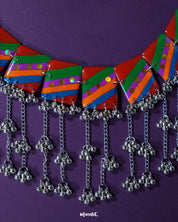 Gulrang multicolor resin jewelry set displayed on a purple background, featuring a silver chain necklace with bold red, green, blue, and purple striped rectangular charms accented with dots and cascading silver bead tassels, paired with matching earrings – Muselot.
