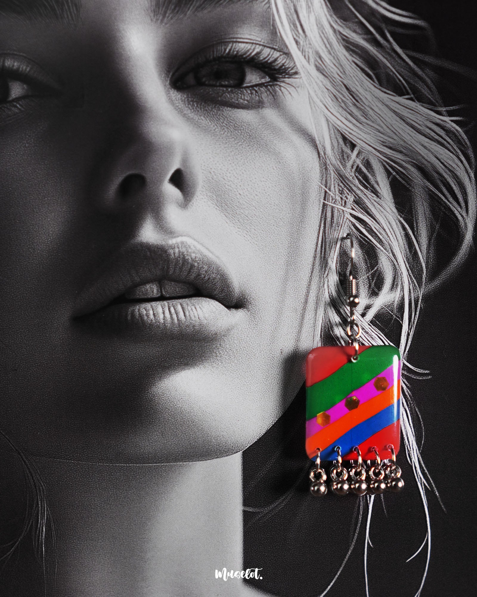 Model wearing the Gulrang multicolor resin earrings, featuring bold red, green, blue, and purple striped rectangular charms with delicate silver bead accents, stylishly showcased to highlight their vibrant and unique design – Muselot.