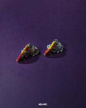 Angled display of Gulrukh floral jhumkas, emphasizing the vibrant floral top and antique-style oxidized silver dome with etched details – Muselot.