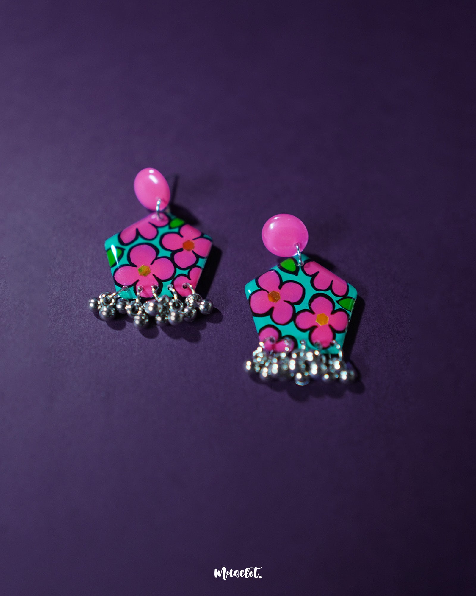 Gulshafa pink floral drop earrings, beautifully set against a soft purple background, with vibrant pink hues and intricate floral details that highlight their playful yet elegant boho charm — Muselot.