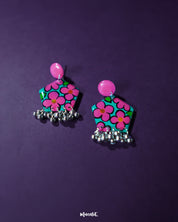 Gulshafa pink floral drop earrings, beautifully set against a soft purple background, with vibrant pink hues and intricate floral details that highlight their playful yet elegant boho charm — Muselot.