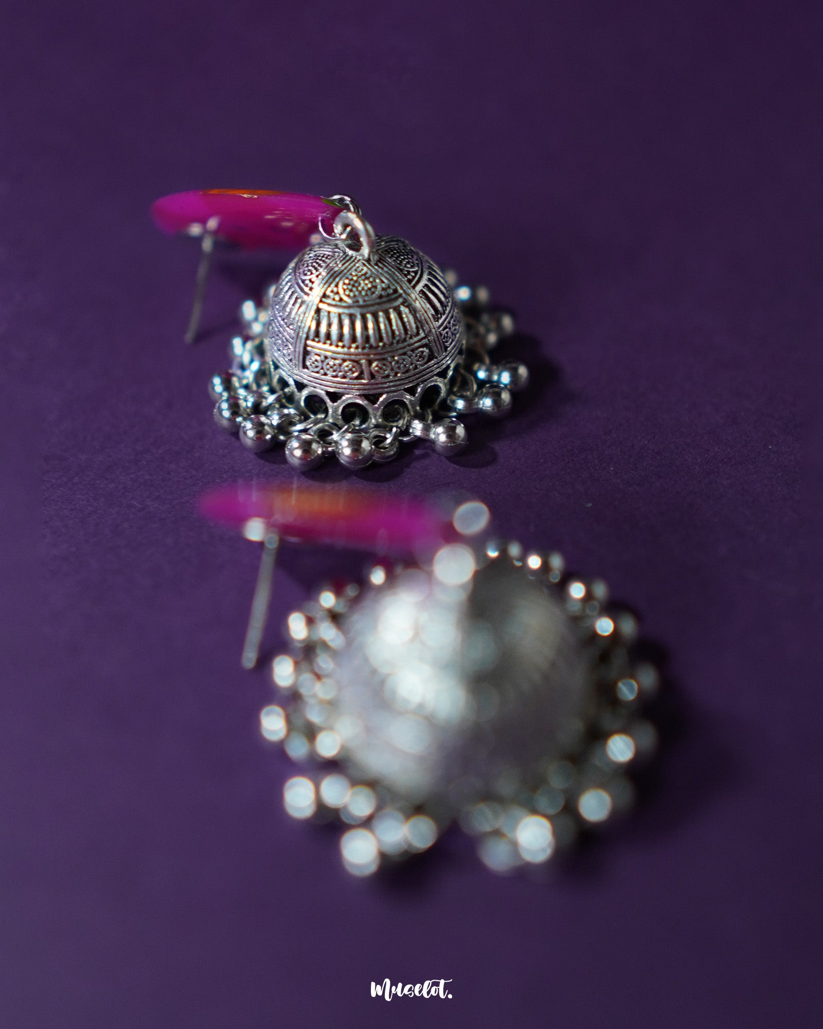 Zoomed-in shot of the bottom part of the Gulzarish floral jhumkas, highlighting the intricately carved oxidized silver dome-shaped drops with delicate hanging beads, showcasing the fine detailing and traditional craftsmanship – Muselot.