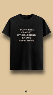 Black graphic t-shirt showcasing the “I Don’t Need ChatGPT My Girlfriend Knows Everything” statement, highlighting a playful, couple-themed attitude against a clean, minimal beige background – Muselot