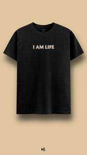 Black graphic t-shirt showcasing the “I Am Life” statement, highlighting a confident, witty, and complementary couple vibe against a clean beige background – Muselot