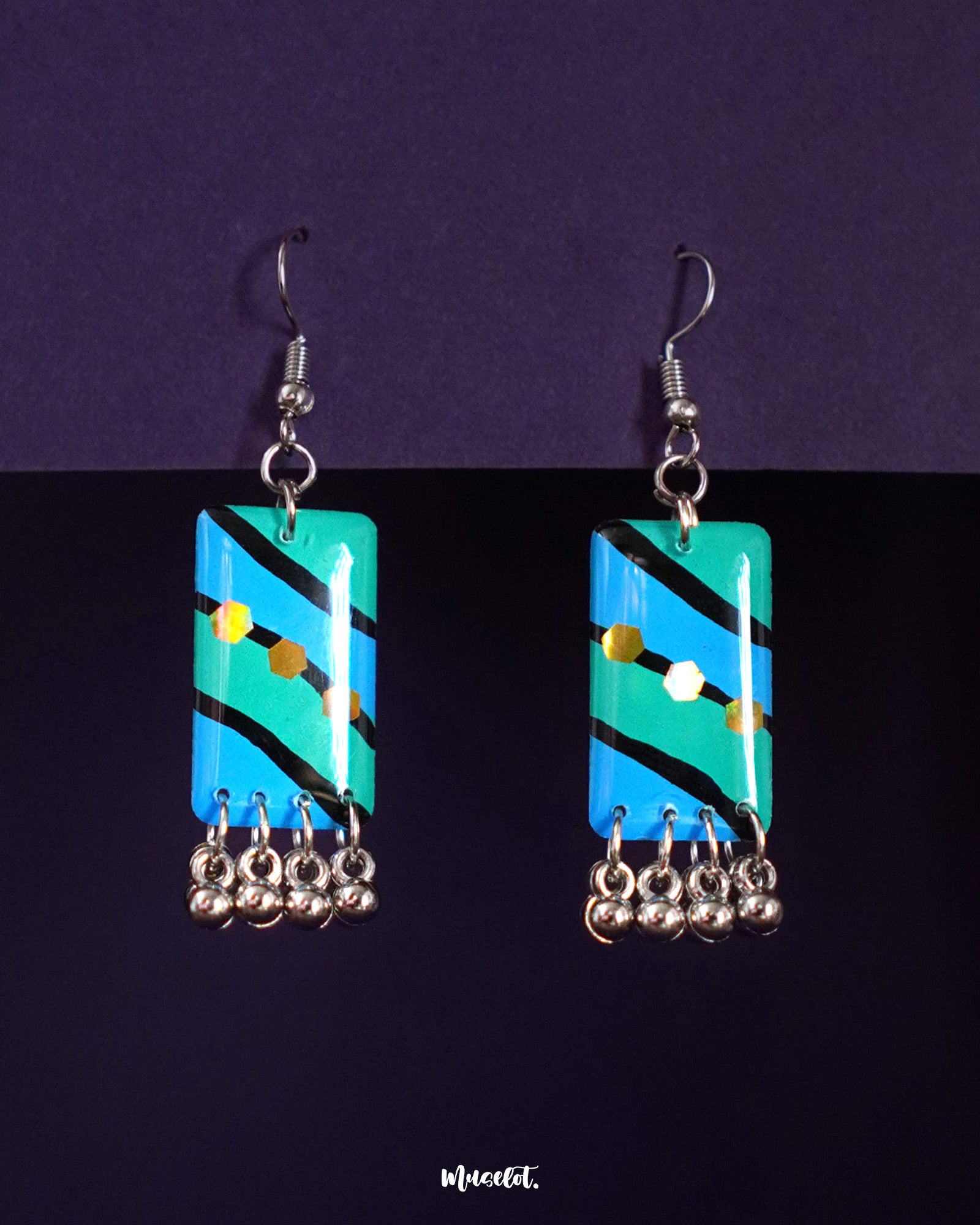 Jaltarang boho drop earrings with a mix of hand-painted aqua and teal tones, detailed with tribal-inspired silver elements and tiny ghungroos, offering a bold yet breezy bohemian charm—Muselot.