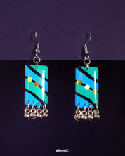 Jaltarang boho drop earrings with a mix of hand-painted aqua and teal tones, detailed with tribal-inspired silver elements and tiny ghungroos, offering a bold yet breezy bohemian charm—Muselot.
