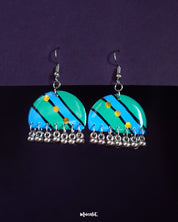 Jaltarang drop earrings featuring a vibrant hand-painted design in turquoise and blue with diagonal stripes, yellow dot accents, and silver ghungroo-style danglers—Muselot.