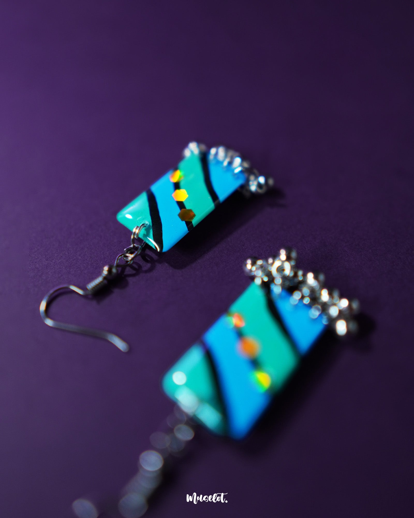 Jaltarang handmade strip hook earrings displayed on a rustic beige background, showcasing their artisan-crafted metallic strands and lightweight hooks for an effortlessly earthy elegance — Muselot.