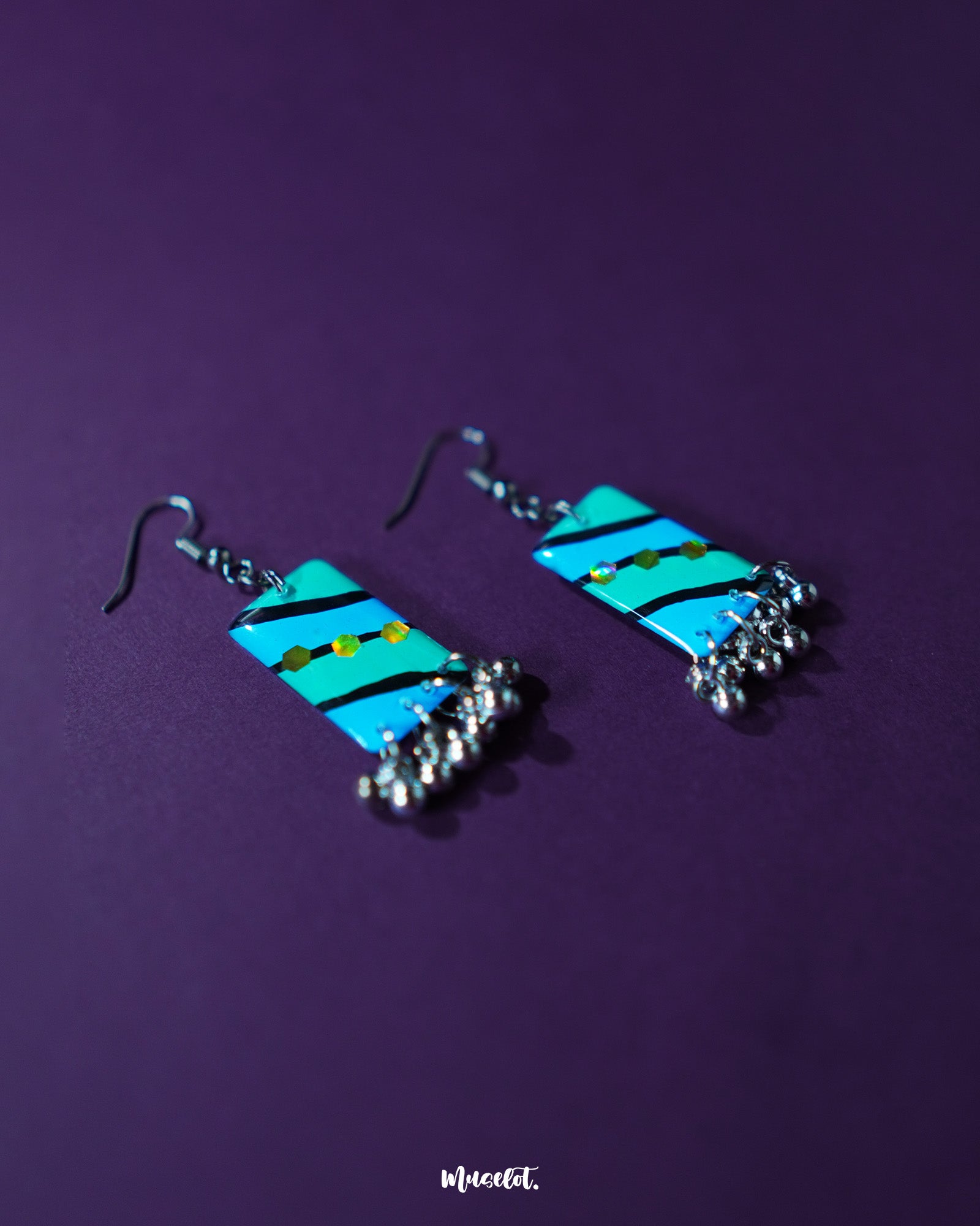 Jaltarang handmade strip hook earrings are placed elegantly on a warm-toned surface, showcasing their sleek, elongated strips and subtle curves that bring a graceful rhythm to everyday styling — Muselot.