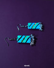 A Jaltarang handmade strip hook earrings resting on a natural background, capturing the smooth finish and handcrafted detailing of the vertical strips that exude minimal elegance — Muselot.