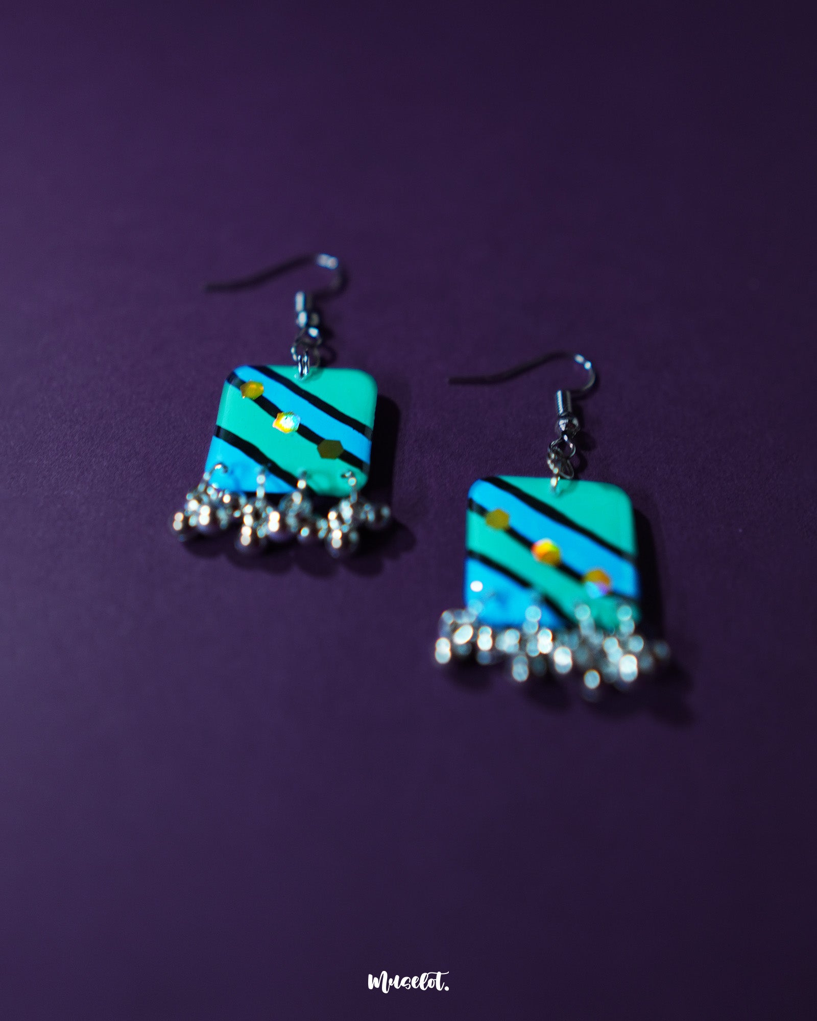 Jaltarang square strip earrings displayed flat, showcasing their geometric square tops with cascading metallic strips below, creating a structured and rhythmic look—Muselot.
