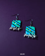 Jaltarang square strip earrings displayed flat, showcasing their geometric square tops with cascading metallic strips below, creating a structured and rhythmic look—Muselot.