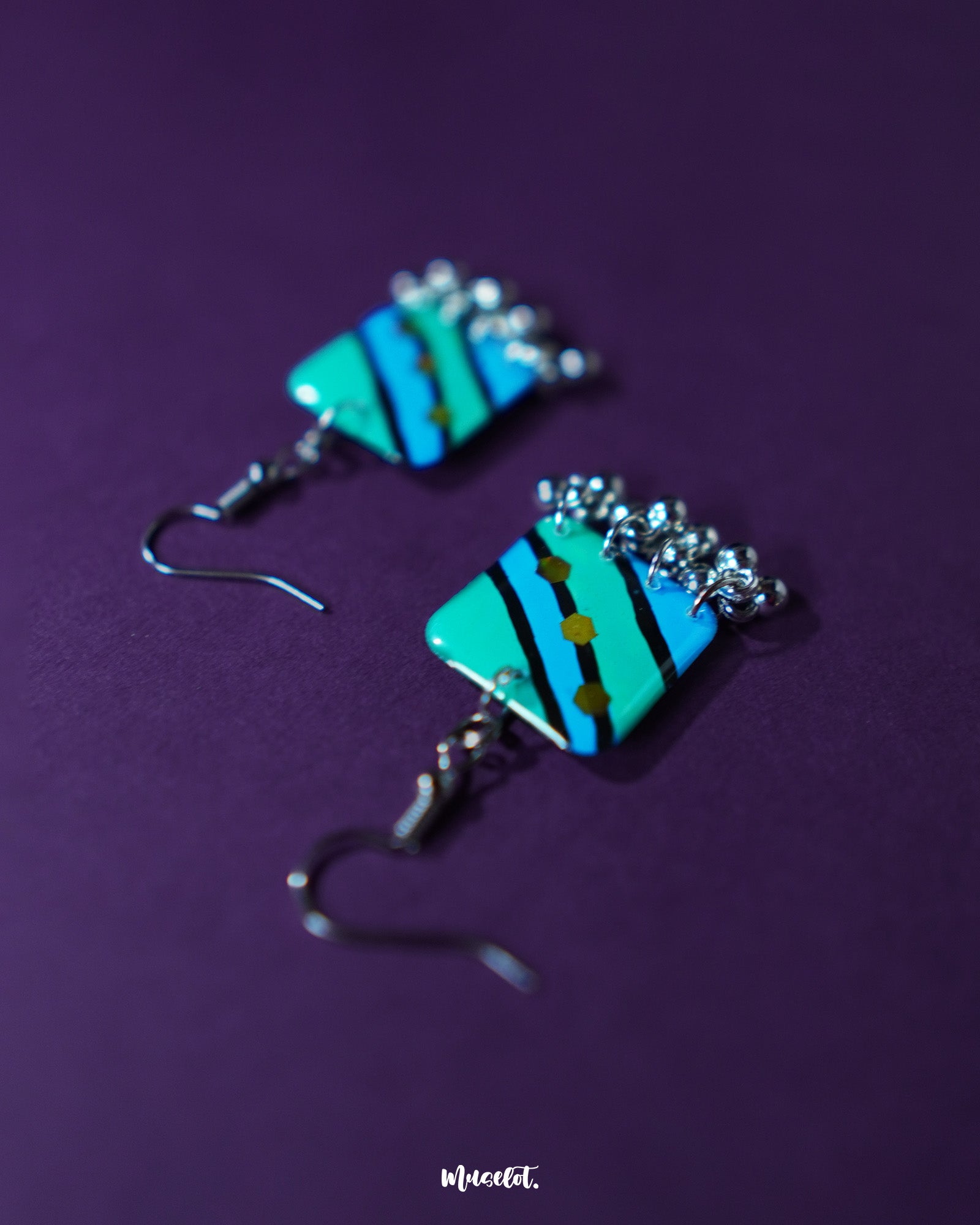 A pair of Jaltarang square strip earrings displayed flat, highlighting their symmetrical square tops and gracefully dangling vertical strips, crafted to add a modern, linear edge to any look — Muselot.