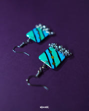 A pair of Jaltarang square strip earrings displayed flat, highlighting their symmetrical square tops and gracefully dangling vertical strips, crafted to add a modern, linear edge to any look — Muselot.