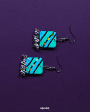 Jaltarang square strip earrings resting elegantly on a soft ivory surface, capturing the interplay of structured squares and fluid metallic strands for a modern boho charm — Muselot.