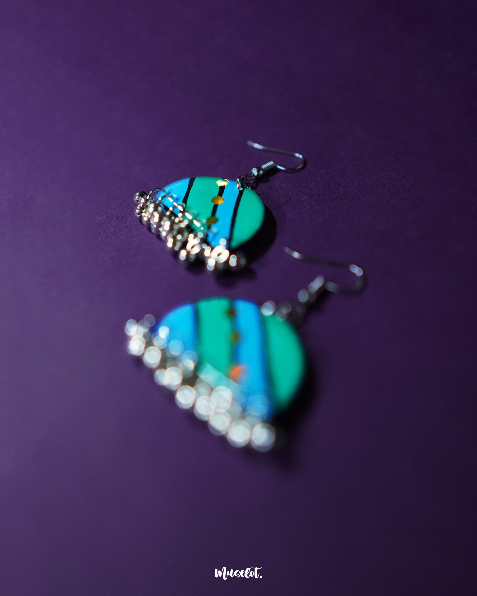 Jaltarang strip earrings displayed on a textured surface, emphasizing their elongated structure and elegant silver tone that reflects boho-meets-modern aesthetics—Muselot.