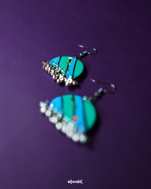 Jaltarang strip earrings displayed on a textured surface, emphasizing their elongated structure and elegant silver tone that reflects boho-meets-modern aesthetics—Muselot.